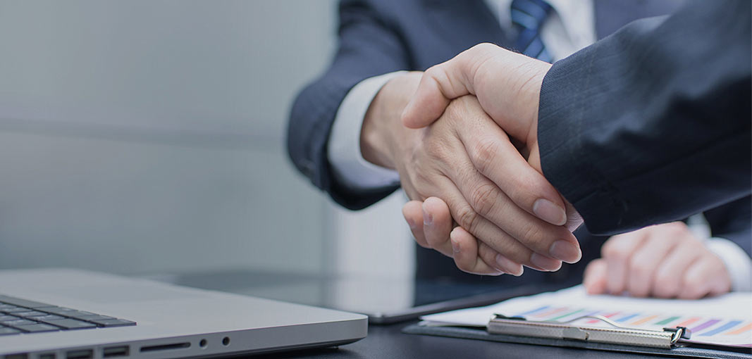 Business partnership handshake